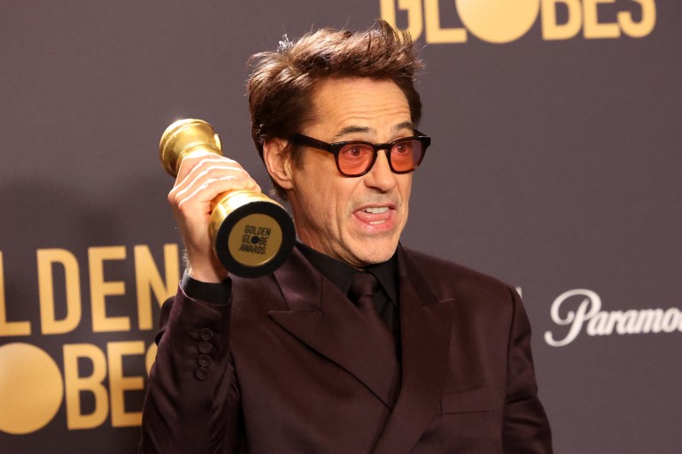 Robert Downey Jr., winner of the award for Best Performance by a Male Actor in a Supporting Role in any Motion Picture for "Oppenheimer", poses at the 81st Annual Golden Globe Awards.