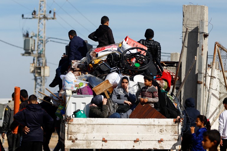 Displaced Palestinians, who fled their houses due to Israeli strikes, ride a vehicle in Rafah in the southern Gaza Strip, January 8, 2024. REUTERS/Ibraheem Abu Mustafa