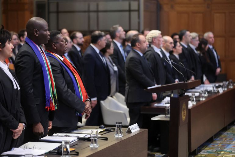 South Africa's Minister of Justice Ronald Lamola and the delegation stand as judges at the International Court of Justice (ICJ) hear a request for emergency measures by South Africa, who asked the court to order Israel to stop its military actions in Gaza and to desist from what South Africa says are genocidal acts committed against Palestinians during the war with Hamas in Gaza, in The Hague, Netherlands, January 11, 2024