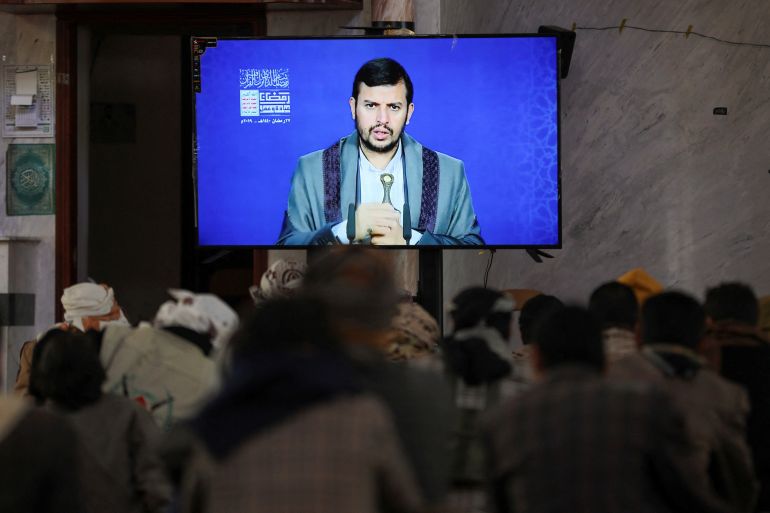 Newly recruited Houthi fighters watch a recorded lecture on Israel and the Jews by the Houthi movement's top leader, Abdul-Malik al-Houthi, during a ceremony at the end of their training in Sanaa, Yemen January 11, 2024. REUTERS/Khaled Abdullah