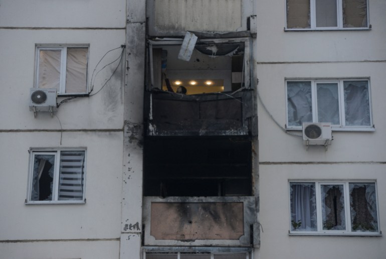 Elena Fedianinova checks her apartment damaged in a reported drone attack in Voronezh, Russia