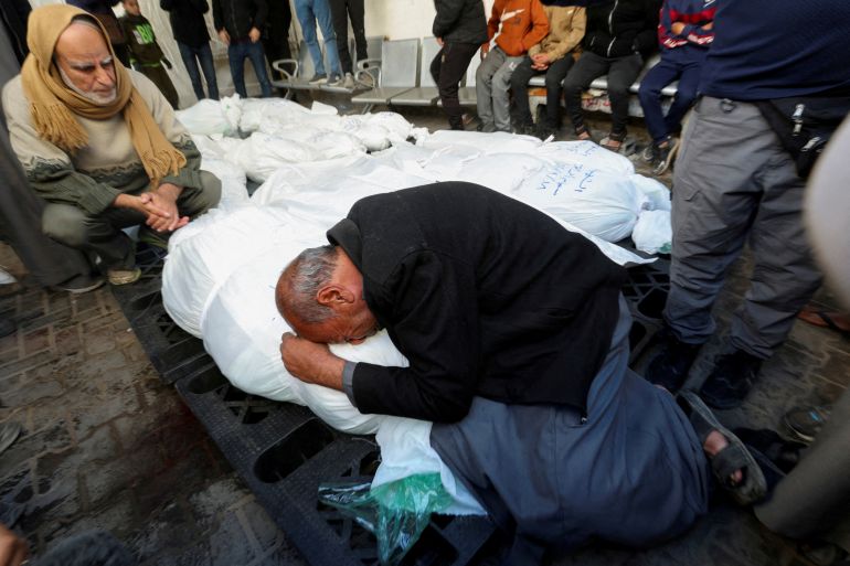 A man mourns over the body of a person killed in an Israeli strike on Gaza