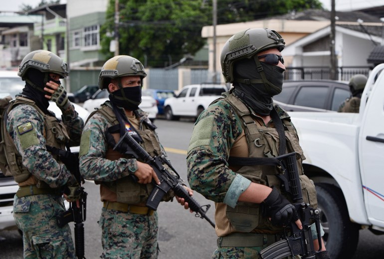 Soldiers stand guard outside of air base Simon Bolivar after the wife and children of fugitive Ecuadorean drug trafficker Jose Adolfo Macias were returned to Ecuador