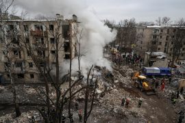 Rescuers work at a site of a residential building heavily damaged during a Russian missile attack