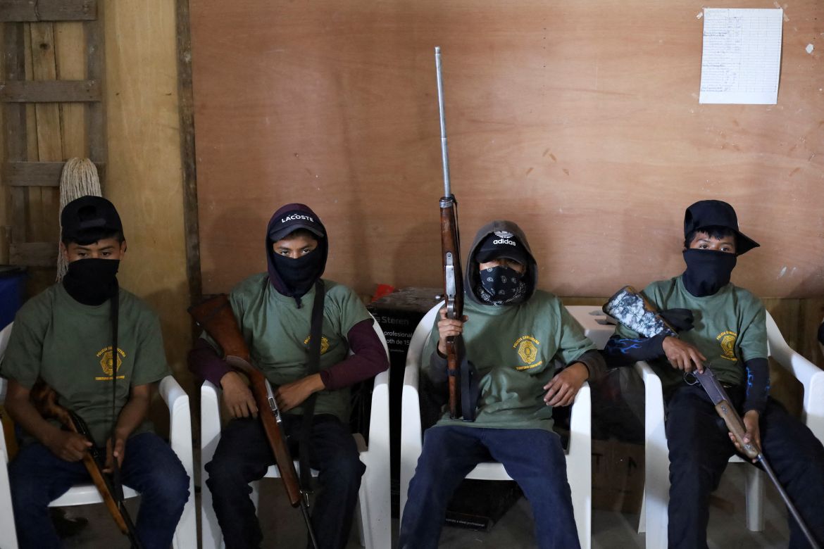 Children hold rifles before a ceremony to join the ranks of the community police, few days after an armed group abducted four people from the community, in Ayahualtempa, Guerrero state, Mexico, January 24