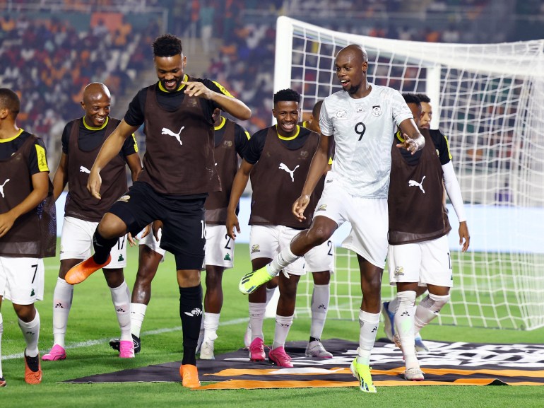 South Africa's Evidence Makgopa celebrates scoring their first goal with teammates 
