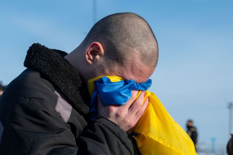 A Ukrainian prisoner of war (POW) reacts after a swap