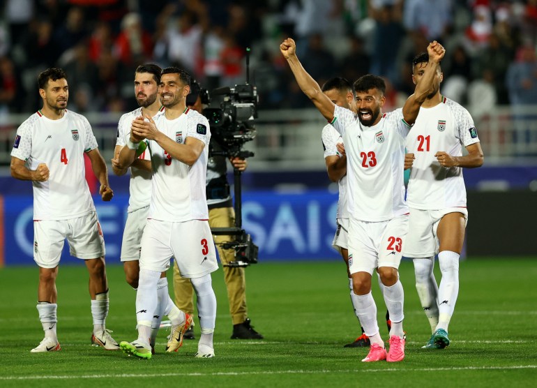 Iranian players celebrate their victory against Syria