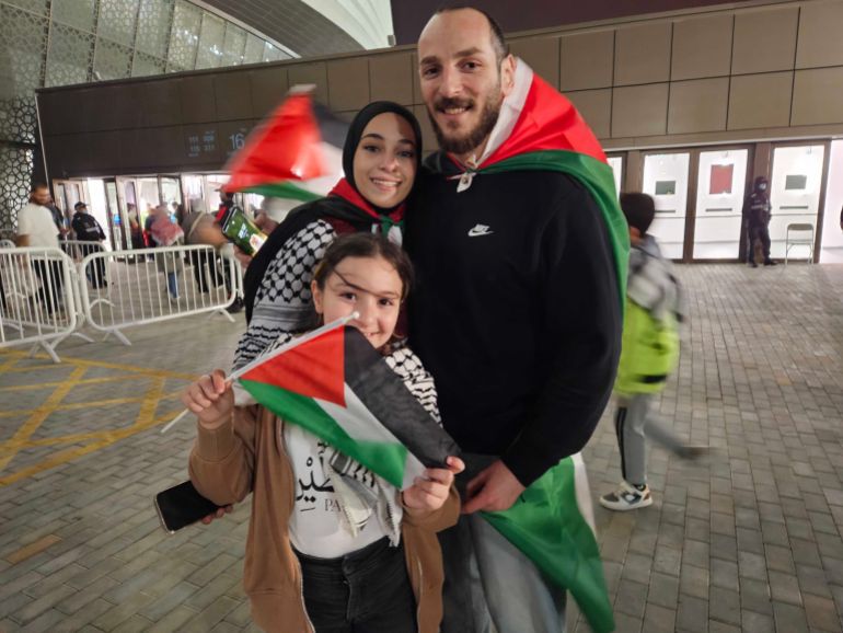 Abdullah Al Hind and his wife Mariana outside the stadium with a Palestine flag