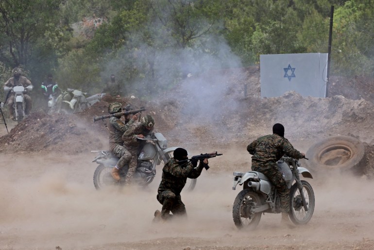Lebanese Hezbollah fighters take part in cross-border raids, part of large-scale military exercise, in Aaramta bordering Israel on May 21, 2023.