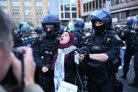 Riot police take a demonstrator away during a pro-Palestinian rally in Frankfurt on October 14, 2023