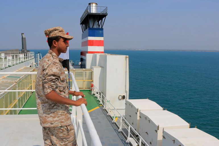 A Houthi guard on the deck of the hijacked Galaxy Leader
