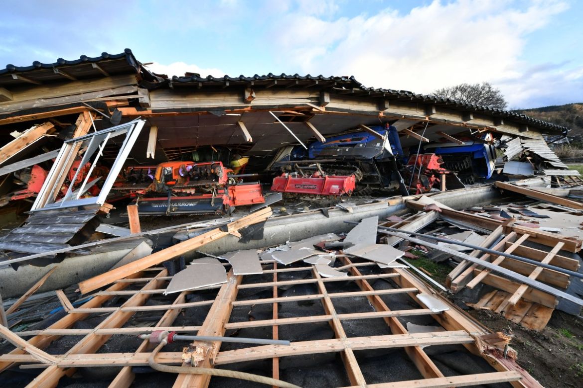 Agricultural machinery and other equipment are seen trapped under a collapsed wooden house in Wajima, Ishikawa prefecture.