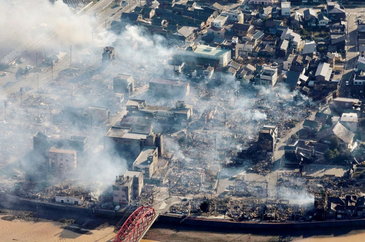 This aerial photo provided by Jiji Press shows smoke rising from an area following a large fire in Wajima, Ishikawa prefecture.