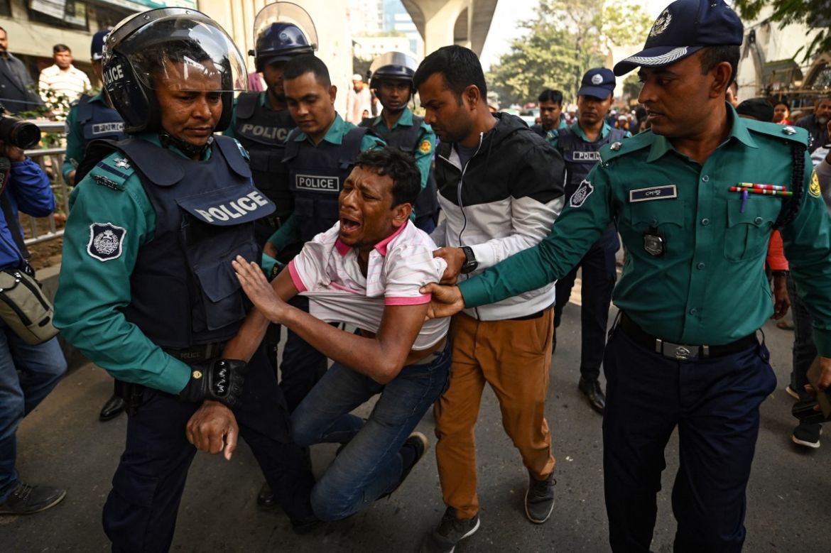 Police personnel detain a man allegedly spouting anti-government slogans at the National Mosque after Friday prayers ahead of the upcoming general elections in Dhaka on January 5, 2024.