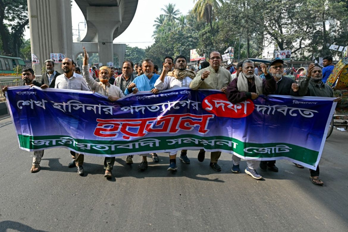 Members of an opposition alliance carry a banner reading 'strike call for resignation of Sheikh Hasina' while chanting anti-government slogans during a protest march on the eve of Bangladesh's general elections in Dhaka on January 6, 2024.