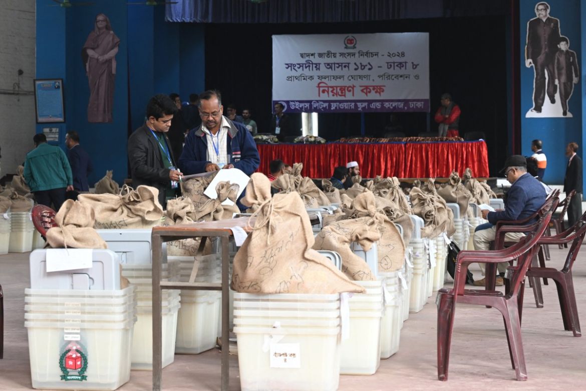 Bangladesh's election officials prepare polling materials at a distributing centre in Dhaka on January 6, 2024, on the eve of Bangladesh's general election.
