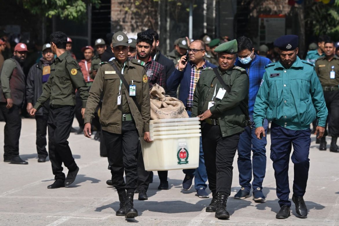 Bangladeshi security personnel carry polling materials outside a distributing centre in Dhaka on January 6, 2024, during preparations on the eve of Bangladesh's general election.