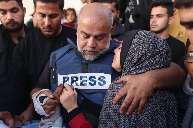Al Jazeera's Gaza bureau chief Wael Dahdouh hugs his daughter during the funeral of his son Hamza, also an Al Jazeera journalist, January 7, 2024
