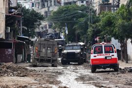 A Red Crescent ambulance parks on the side of the road as Israeli troops enter the Tulkarem Palestinian refugee camp during a raid