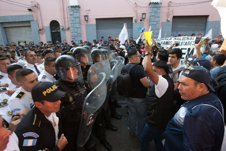 Police and Arevalo supporters face off in Guatemala City, as the country's Congress delayed new President Bernardo Arevalo's swearing in on January 14, 2024 [Jeff Abbott/Al Jazeera]