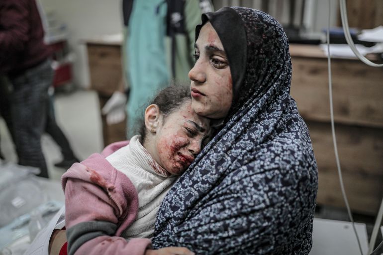 Image depicts graphic content) An injured Palestinian mother and her daughter are brought to Nasser Hospital