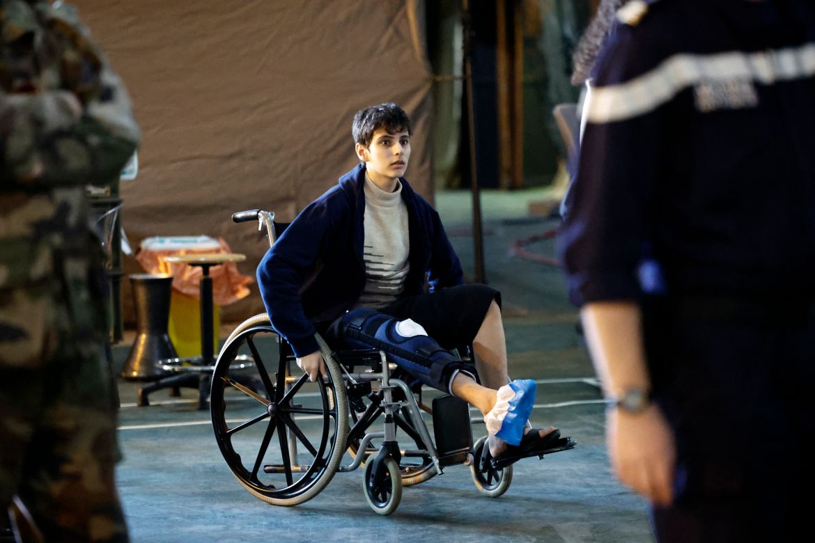 A Palestinian youth pushes his wheelchair onboard the French LHD Dixmude military ship, which serves as a hospital to treat wounded Palestinians, as it docks at the Egyptian port of Al-Arish on January 21