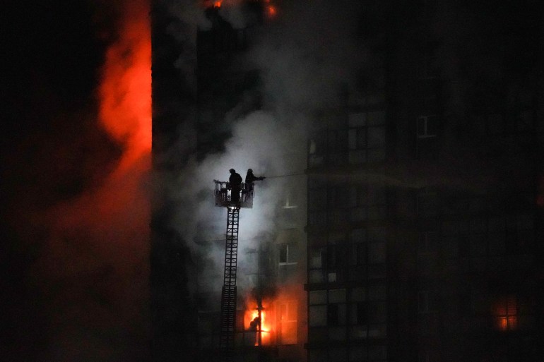 Firefighters tend to a blaze at the scene of an explosion from a vehicle crash in Ulaanbaatar, the capital of Mongolia 