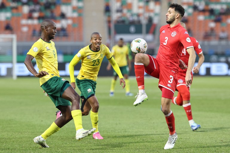 Tunisia's defender #3 Montassar Talbi controls the ball as South Africa's forward #9 Evidence Makgopa and South Africa's defender #23 Thapelo Morena react