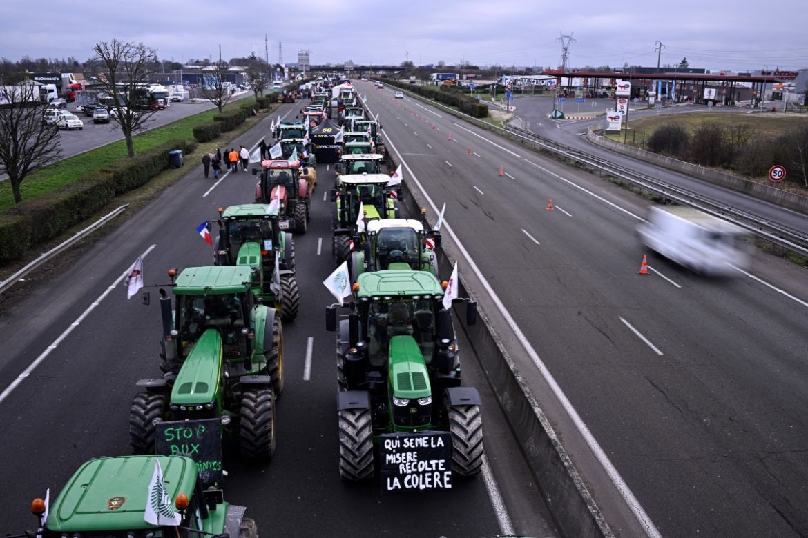 Farmers drive their tractors during a protest