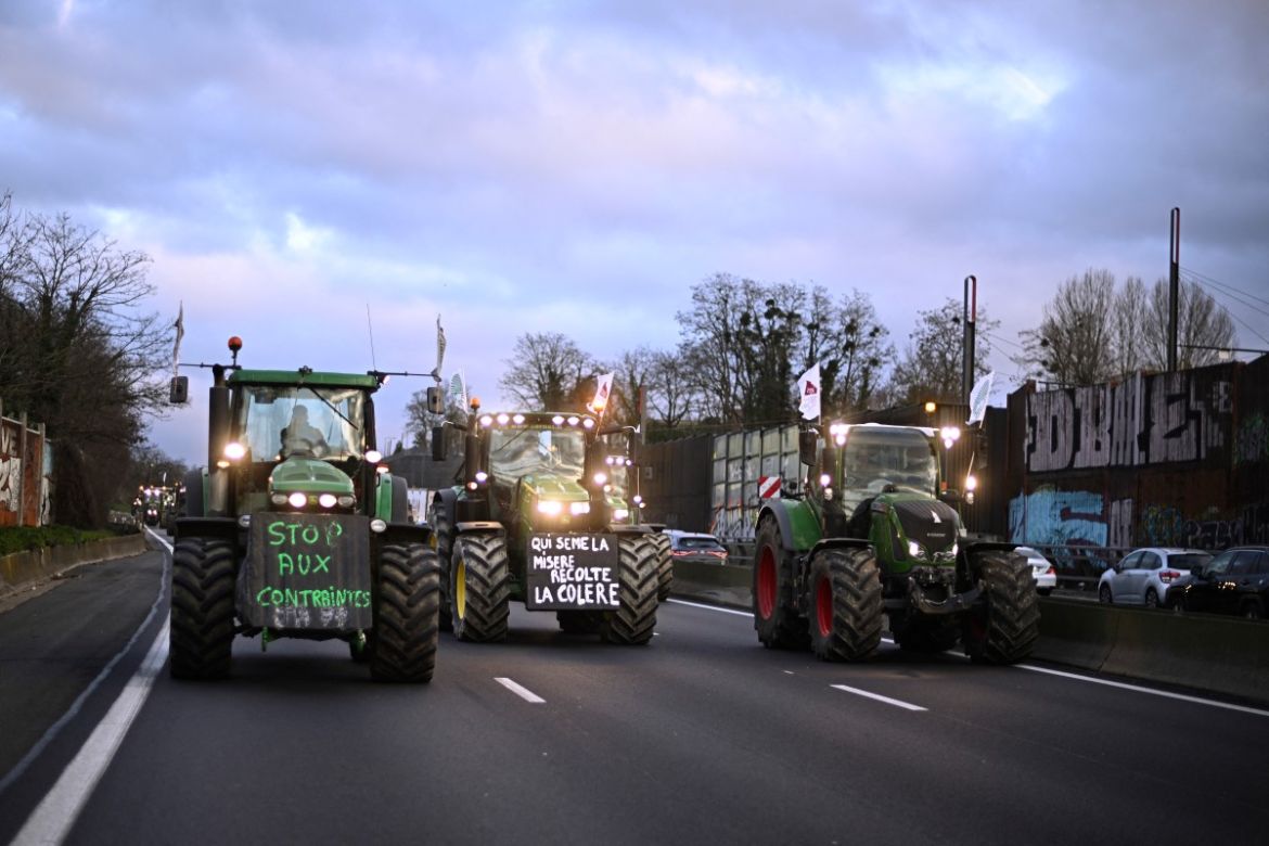 Farmers drive their tractors during a protest