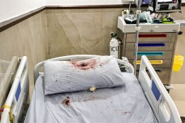 A bullet hole is pictured on a pillow covered in blood on a hospital bed at the Ibn Sina hospital in Jenin in the occupied West Bank on January 30, 2024. Israeli forces shot dead three Palestinians at the hospital early on January 30,[Zain Jaafar/ AFP]