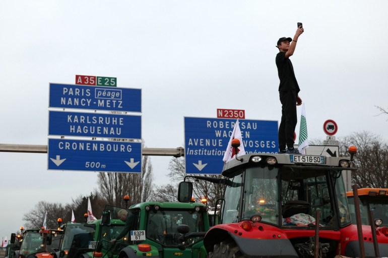 Farmers drive their tractors during a demonstration