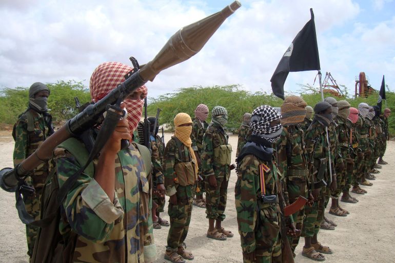 Al-Shabaab fighters display weapons as they conduct military exercises in northern Mogadishu, Somalia