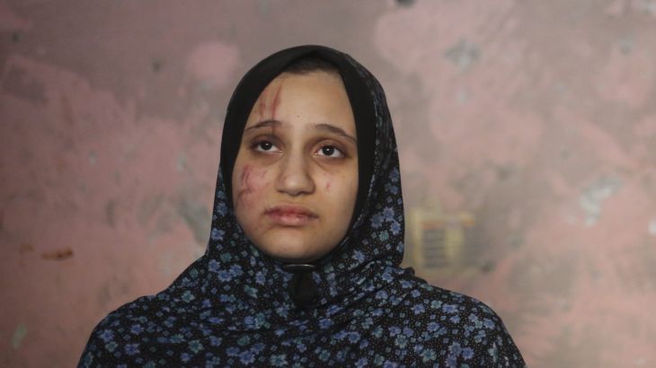 A Palestinian woman stands in her home after an Israeli strike in Rafah
