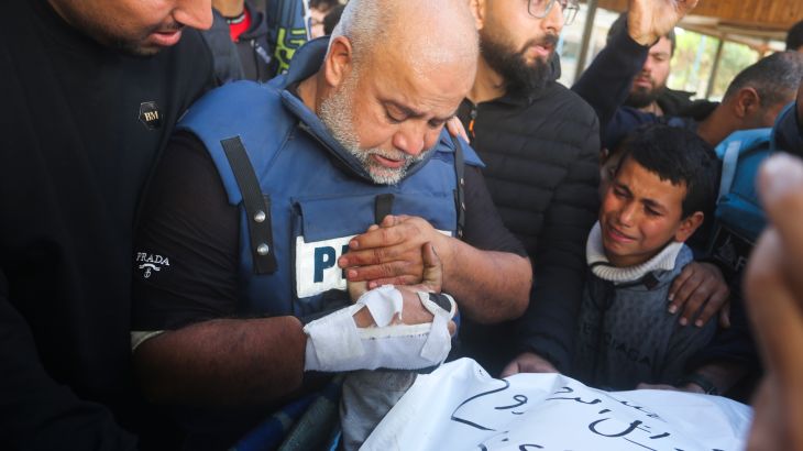Al Jazeera journalist Wael Dahdouh holds the hand of his son Hamza, who also worked for Al Jazeera and who was killed in an Israeli airstrike in Rafah, Gaza Strip, Sunday, Jan. 7, 2024