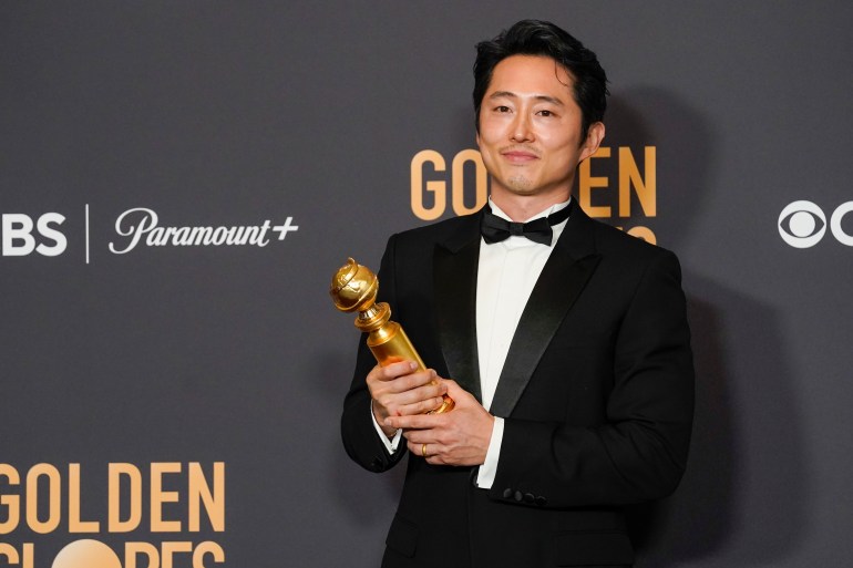 Steven Yeun poses in the press room with the award for best performance by an actor in a limited series, anthology series, or a motion picture made for television for "Beef" at the 81st Golden Globe Awards on Sunday