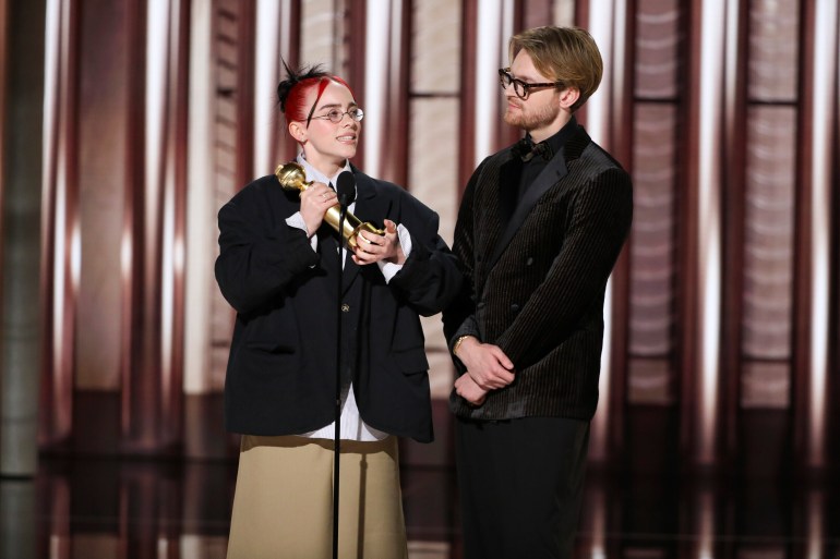 Billie Eilish and her brother Finneas O'Connell collect their Golden Globe.