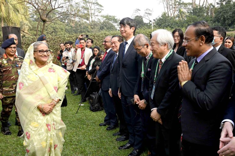 In this photograph released by Bangladesh Prime Minister's office, Prime Minister Sheikh Hasina, left, arrives to address a press conference following her election victory in Dhaka, Bangladesh, Monday, Jan.8, 2024. (Bangladesh Prime Minister's office via AP)