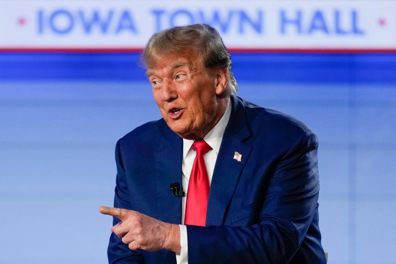 Donald Trump aponta no palco da prefeitura de Iowa em 10 de janeiro.