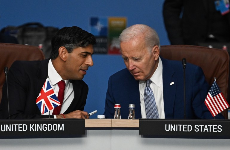 Britain's Prime Minister Rishi Sunak, left, and U.S. President Joe Biden speak at the start of the meeting of the North Atlantic Council (NAC) during the NATO Summit in Vilnius, Lithuania, July 11, 2023.