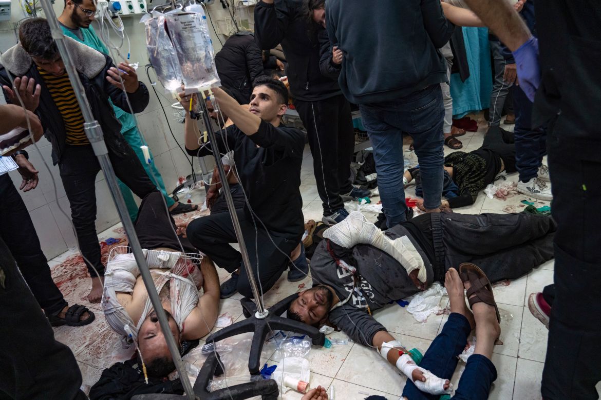 Palestinians are treated as they lie on the floor after being wounded in an Israeli army bombardment of the Gaza Strip, in the hospital in Khan Younis, Tuesday, Dec. 5