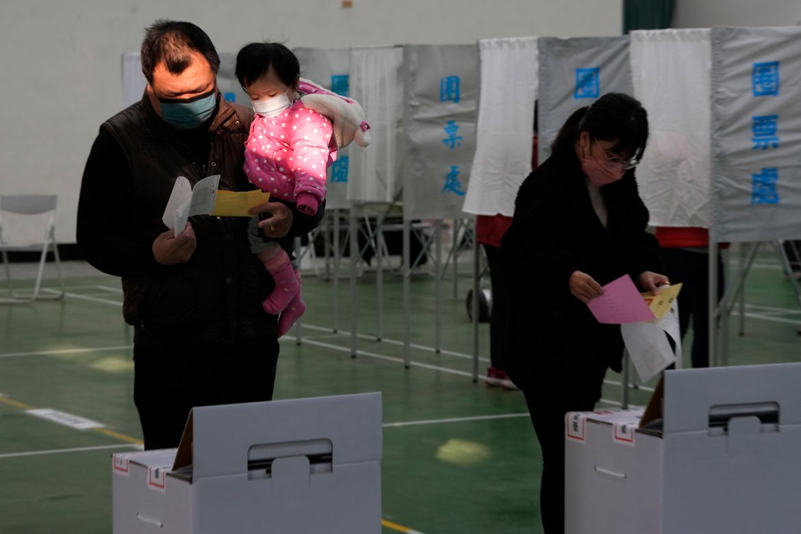 People vote for the presidential election at a polling station in southern Taiwan's Tainan city on Saturday, Jan. 13
