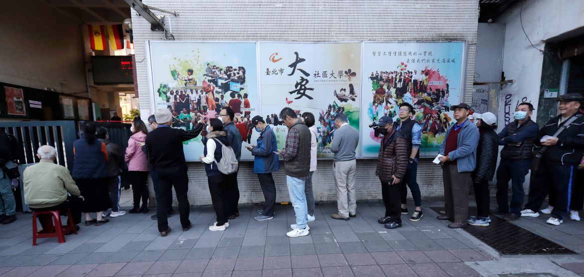 Taiwanese people line up to vote outside of a polling station in Taipei, Taiwan, Saturday, Jan. 13,