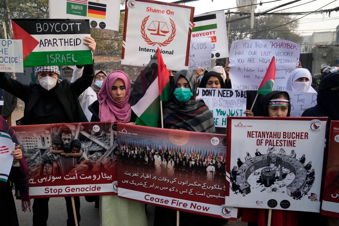 Pakistani people hold placards during a protest against Israeli airstrikes and to show solidarity with Palestinian people in Gaza, in Lahore