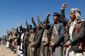 Houthi fighters and tribesmen stage a rally against the U.S. and the U.K. strikes on Houthi-run military sites near Sanaa