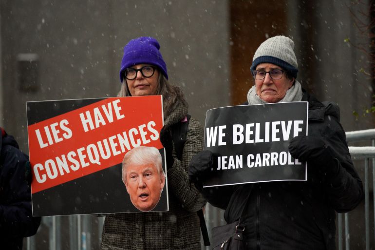 People carry anti-Trump signs outside federal court,