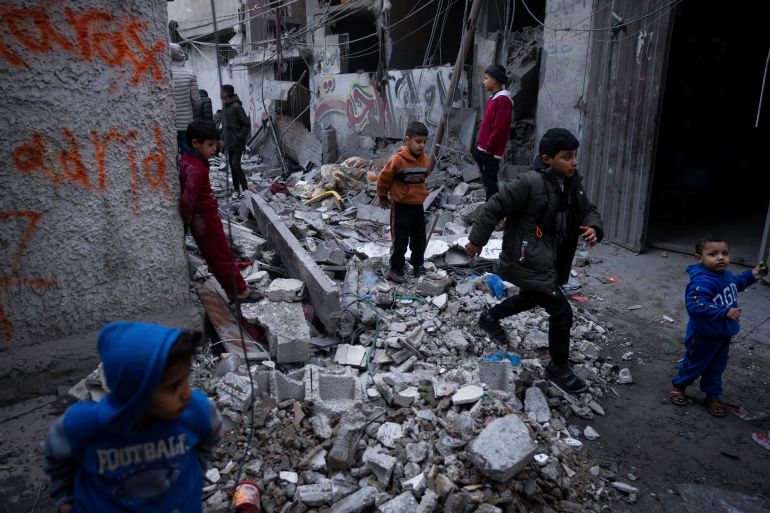Palestinians look at the destruction after an Israeli strike in Rafah, southern Gaza Strip, Wednesday, Jan. 17, 2024. (AP Photo/Fatima Shbair)
