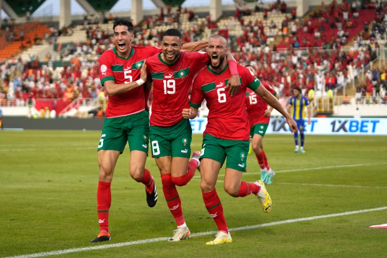 Morocco's Romain Saiss, right, celebrates with teammates after scoring his side's opening goal during the African Cup of Nations Group F soccer match between Morocco and Tanzania at the Laurent Pokou stadium in San Pedro, Ivory Coast, Wednesday, Jan. 17, 2024. (AP Photo/Themba Hadebe)