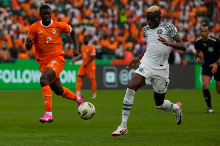 Nigeria's Victor Osimhen, right, is challenged by Ivory Coast's Ousmane Diomande